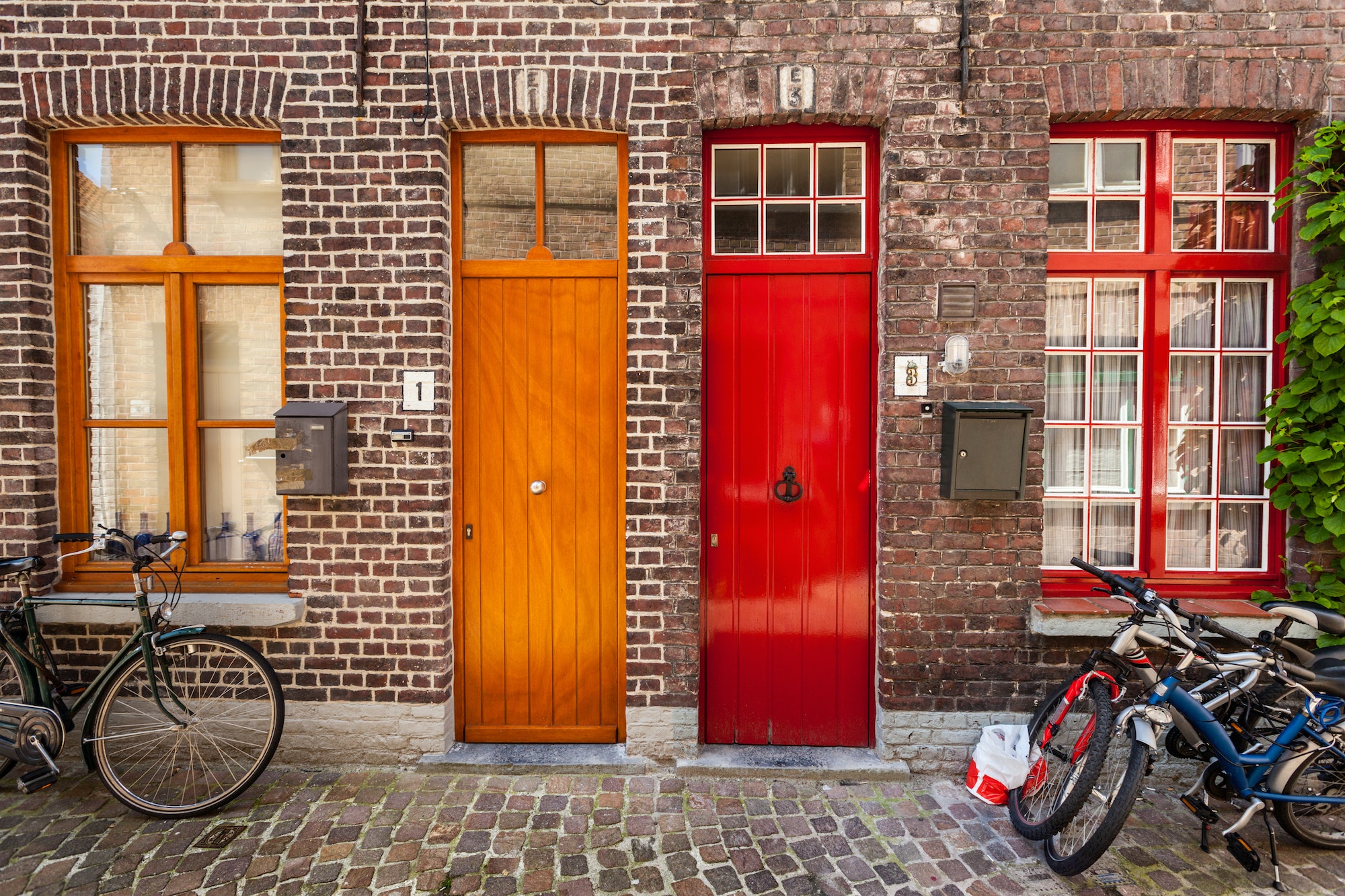 Doors of old houses and bicycles in european city Bruges (Brugge